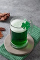 Patrick's day green beer in pint and jerky on gray background. Patrick's day green beer in pint and jerky on gray background. - PhotoDune Item for Sale