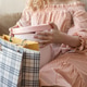 A blonde in a long pink dress poses by the window unwrapping gifts on International Women's Day. A blonde in a long pink dress poses by the window unwrapping gifts on International Women's Day. - PhotoDune Item for Sale