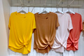 Summer plain color women’s tees hanging on white hangers and Mockup friendly. Summer plain color women’s tees hanging on white hangers and Mockup friendly. - PhotoDune Item for Sale