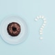 A donut with sugar on a blue background. A donut with sugar on a blue background. - PhotoDune Item for Sale