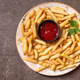 French fries and tomato ketchup on a rustic plate. French fries and tomato ketchup on a rustic plate. - PhotoDune Item for Sale