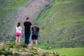 Back view three young hikers stand in the beautiful mountains Back view three young hikers stand in the beautiful mountains - PhotoDune Item for Sale