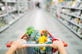 Female person hands drags the cart full of goods Female person hands drags the cart full of goods - PhotoDune Item for Sale