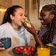 Lesbian couple sharing a healthy breakfast at home Lesbian couple sharing a healthy breakfast at home - PhotoDune Item for Sale