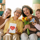 Happy Multigenerational Family Celebrating Together with Flowers and Gifts at Home Happy Multigenerational Family Celebrating Together with Flowers and Gifts at Home - PhotoDune Item for Sale