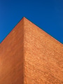 A wall of brick against a blue sky. Abstract shapes of buildings in the city. A wall of brick against a blue sky. Abstract shapes of buildings in the city. - PhotoDune Item for Sale