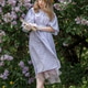 A beautiful young blonde woman, against a background of blooming lilacs, in a lilac vintage dress A beautiful young blonde woman, against a background of blooming lilacs, in a lilac vintage dress - PhotoDune Item for Sale