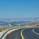 Curved mountain road with guardrails and directional signs, offering Curved mountain road with guardrails and directional signs, offering - PhotoDune Item for Sale