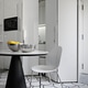 Close-up of a modern wooden dining table and chair against a white lacquered kitchen cabinet.g Close-up of a modern wooden dining table and chair against a white lacquered kitchen cabinet.g - PhotoDune Item for Sale