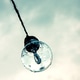 Wet Light Bulb Hanging Against a Cloudy Sky Wet Light Bulb Hanging Against a Cloudy Sky - PhotoDune Item for Sale