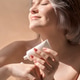 Woman with light hair applying skincare cream to her arm, enjoying a moment of self-care Woman with light hair applying skincare cream to her arm, enjoying a moment of self-care - PhotoDune Item for Sale