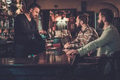 Cheerful old friends drinking draft beer at bar counter in pub. Cheerful old friends drinking draft beer at bar counter in pub. - PhotoDune Item for Sale
