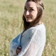 Young woman standing in sunlit rye field with soft smile and natural surroundings Young woman standing in sunlit rye field with soft smile and natural surroundings - PhotoDune Item for Sale