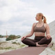 Woman practicing yoga outdoors on sand near lake, seated twist pose Woman practicing yoga outdoors on sand near lake, seated twist pose - PhotoDune Item for Sale