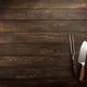 Vintage meat knife and fork over wooden board Vintage meat knife and fork over wooden board - PhotoDune Item for Sale