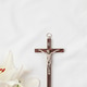 A symbolic Christian composition with christian cross lies beside a fresh white lily A symbolic Christian composition with christian cross lies beside a fresh white lily - PhotoDune Item for Sale