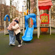 Playing mother with child on playground slide. Hugging family moment supports love, care Playing mother with child on playground slide. Hugging family moment supports love, care - PhotoDune Item for Sale