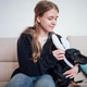 Young woman with long hair placing bunny ears on a black dog Young woman with long hair placing bunny ears on a black dog - PhotoDune Item for Sale
