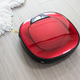 Modern red robot vacuum cleaner on laminate floor top view close-up. Modern red robot vacuum cleaner on laminate floor top view close-up. - PhotoDune Item for Sale