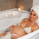 Pregnant Woman Relaxing in Bathtub with Candles Pregnant Woman Relaxing in Bathtub with Candles - PhotoDune Item for Sale