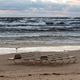Stretch of sandy beach in Jurmala, Latvia with a bench facing the calm sea at sunset. Stretch of sandy beach in Jurmala, Latvia with a bench facing the calm sea at sunset. - PhotoDune Item for Sale