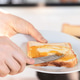 Person Spreading Butter On Toast At Home Person Spreading Butter On Toast At Home - PhotoDune Item for Sale