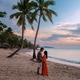 Couple enjoying a romantic sunset at a tropical beach in Saint Lucia Couple enjoying a romantic sunset at a tropical beach in Saint Lucia - PhotoDune Item for Sale