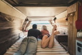 couple in vacation viewed from inside an old restored van couple in vacation viewed from inside an old restored van - PhotoDune Item for Sale