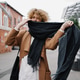 Stylish woman with curly hair walking in the city wearing a brown coat and jeans Stylish woman with curly hair walking in the city wearing a brown coat and jeans - PhotoDune Item for Sale