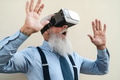 Senior fashion man having fun playing with innovated virtual reality glasses Senior fashion man having fun playing with innovated virtual reality glasses - PhotoDune Item for Sale