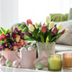 Easter Table with Tulip Bouquets, Eggs, Candles and Festive Decor. Cozy Spring Arrangement Easter Table with Tulip Bouquets, Eggs, Candles and Festive Decor. Cozy Spring Arrangement - PhotoDune Item for Sale