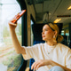 Attractive caucasian woman using a smartphone in regional train. Attractive caucasian woman using a smartphone in regional train. - PhotoDune Item for Sale