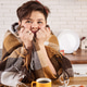 Pensive woman in blanket at kitchen table with coffee cups and sandwiches Pensive woman in blanket at kitchen table with coffee cups and sandwiches - PhotoDune Item for Sale
