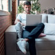 Smart man working with her laptop while sitting on a couch at home Smart man working with her laptop while sitting on a couch at home - PhotoDune Item for Sale