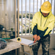 Man marking marks with pencil on a tile to be cut. Laying ceramic floor tiles, home renovation. Man marking marks with pencil on a tile to be cut. Laying ceramic floor tiles, home renovation. - PhotoDune Item for Sale