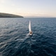 Aerial video of a sailboat cruising near a scenic coastline on a calm sea. Peaceful maritime landsca Aerial video of a sailboat cruising near a scenic coastline on a calm sea. Peaceful maritime landsca - PhotoDune Item for Sale