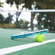 Tennis racket and ball on the court. Tennis racket and ball on the court. - PhotoDune Item for Sale