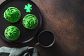 Three chocolate cupcakes with green whipped cream and chocolate sprinkles. Three chocolate cupcakes with green whipped cream and chocolate sprinkles. - PhotoDune Item for Sale