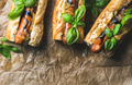 Homemade grilled sausage dogs in baguette on baking paper Homemade grilled sausage dogs in baguette on baking paper - PhotoDune Item for Sale