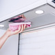 A Person Cleaning a Kitchen Range Hood with a Pink Cloth, Highlighting Home Care A Person Cleaning a Kitchen Range Hood with a Pink Cloth, Highlighting Home Care - PhotoDune Item for Sale