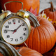 An old fashion alarm clock is nestled amongst harvested pumpkins and autumn leavesNOMINATED An old fashion alarm clock is nestled amongst harvested pumpkins and autumn leavesNOMINATED - PhotoDune Item for Sale