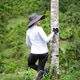 Woman hiking enjoying nature resting beside tree Woman hiking enjoying nature resting beside tree - PhotoDune Item for Sale