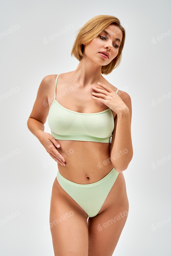 Sexy young blonde woman with natural makeup in light green lingerie touching chest and looking away Stock Photo by LightFieldStudios Sexy young blonde woman with natural makeup in light green lingerie touching chest and looking away Stock Photo by LightFieldStudios