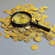 Close up of magnifying glass exploring a pile of coins for financial audit and tax investigation Close up of magnifying glass exploring a pile of coins for financial audit and tax investigation - PhotoDune Item for Sale