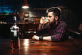 Man sitting at the bar and drink strong alcohol Man sitting at the bar and drink strong alcohol - PhotoDune Item for Sale
