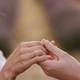 Caucasian bride and a groom holding hands, wearing wedding rings on their fingers. Caucasian bride and a groom holding hands, wearing wedding rings on their fingers. - PhotoDune Item for Sale