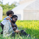 A father and daughter share a tender moment in a green field near greenhouses. A father and daughter share a tender moment in a green field near greenhouses. - PhotoDune Item for Sale