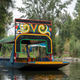 Colorful trajinera boat gliding through the serene canals of Xochimilco, Mexico Colorful trajinera boat gliding through the serene canals of Xochimilco, Mexico - PhotoDune Item for Sale