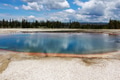 Landscape view of Yellowstone geyser reflecting some clouds and mountains and trees in background Landscape view of Yellowstone geyser reflecting some clouds and mountains and trees in background - PhotoDune Item for Sale