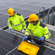 Workers install solar panels on a rooftop in a sunny environment during the day Workers install solar panels on a rooftop in a sunny environment during the day - PhotoDune Item for Sale
